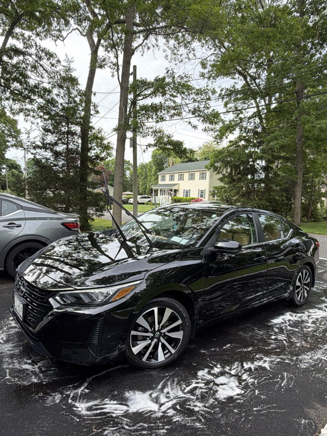 Black Nissan Sentra after a full exterior detail with foam wash — Port Jefferson Station NY